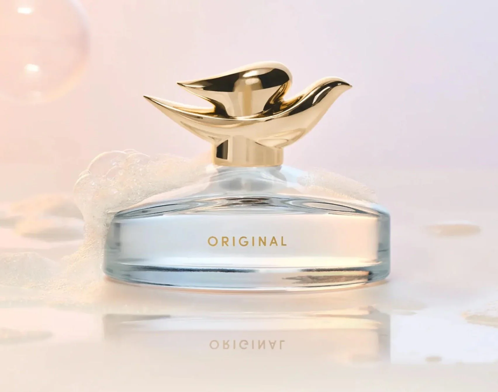 Dove lança perfume com cheiro do sabonete original 3 Frasco do perfume da Dove com tampa dourada em forma de pássaro